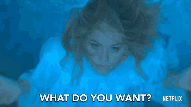 a woman is swimming underwater with the words " what do you want " written below her