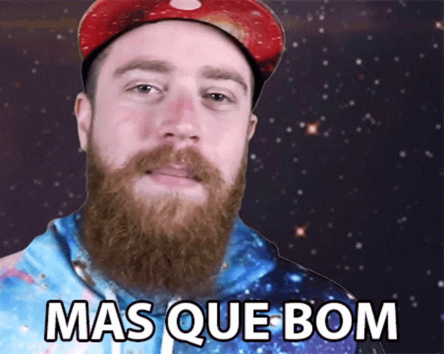 a man with a beard is wearing a red hat and a blue hoodie with the words mas que bom on it