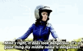 a woman wearing a helmet is riding a bike and saying mike 's right
