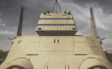 a large military vehicle is being lifted by a crane in the sky .