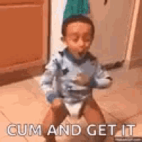 a little boy is sitting on the floor with a diaper on and the words `` cum and get it '' .