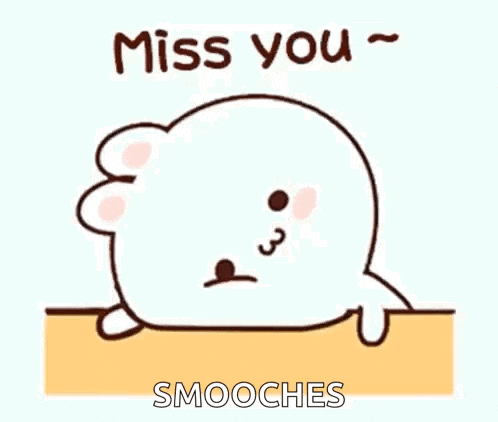 a cartoon seal is laying on a table with the words `` miss you smooches '' .