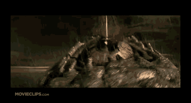 a movie clip from movieclips.com shows a man holding a knife in the air