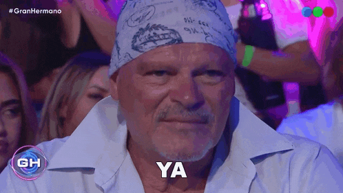 a man wearing a bandana says ya in front of a crowd