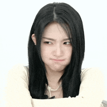 a woman with long black hair is making a face
