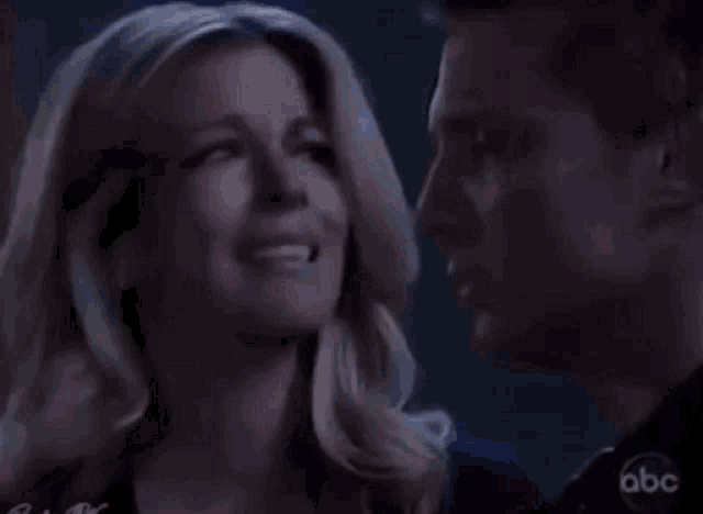 a man and a woman are looking at each other .