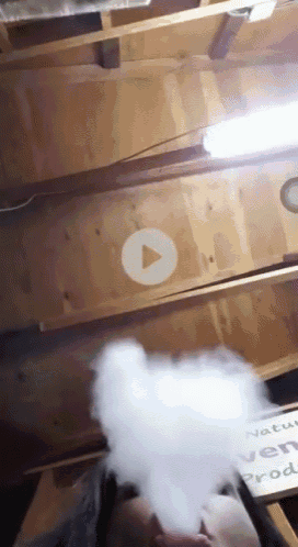 a video of a person smoking a cigarette with a play button in the middle of it