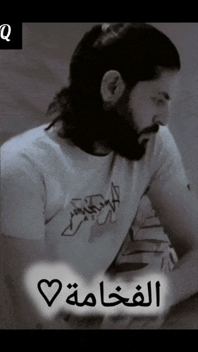 a man with a beard is wearing a white shirt that says ' abercrombie & fitch ' on it