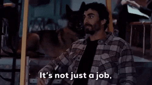 a man holding a bottle of beer says it 's not just a job .