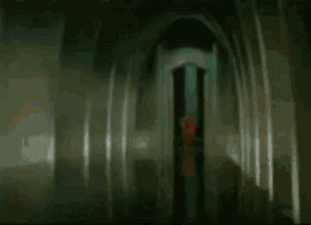 a blurred image of a man standing in a dark room