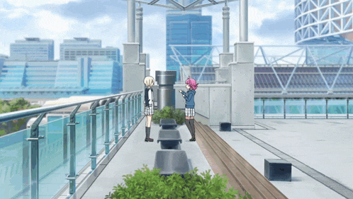 a couple of girls standing on a balcony with a city skyline in the background