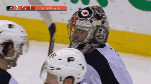 a hockey game is being played and the flyers are winning 2 to 1