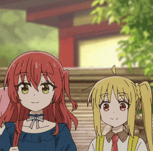 a girl with red hair and a girl with blonde hair are standing next to each other
