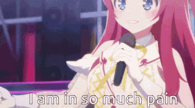 a girl with pink hair is holding a microphone and says i am in so much pain .