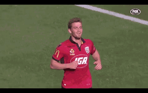 a couple of soccer players are hugging each other on a field .