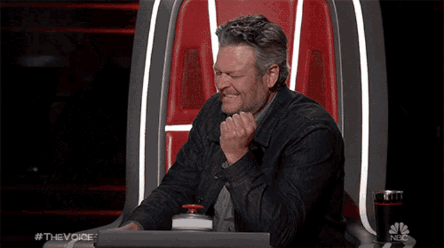 a man and two women are sitting in front of a sign that says " the voice "
