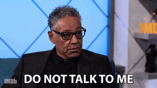 a man in a suit and glasses says " do not talk to me "