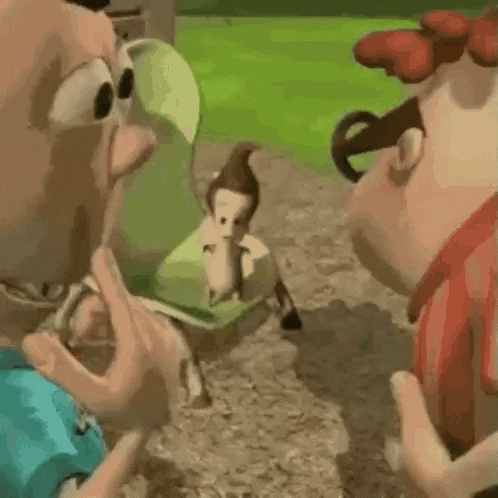 a couple of cartoon characters are standing next to each other on a dirt road .