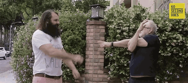 two men are standing next to each other with a sign that says 60 second docs