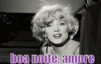 a black and white photo of marilyn monroe with the words boa noite amore written below her