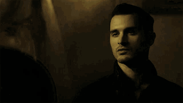 a man in a black shirt is looking at something