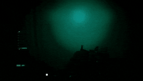 a person holding a gun in a dark room with a baby crib