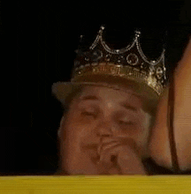 a man wearing a crown and a hat .