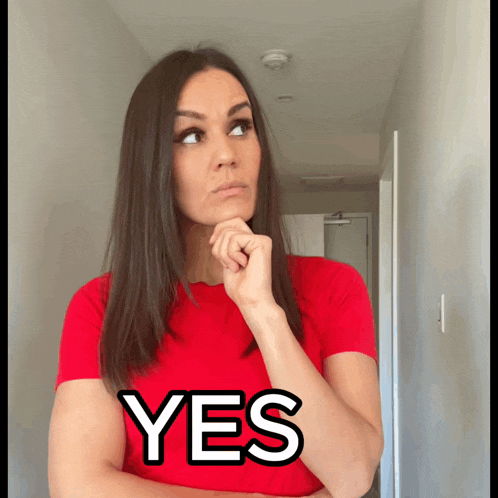 a woman in a red shirt has the word yes on her chest