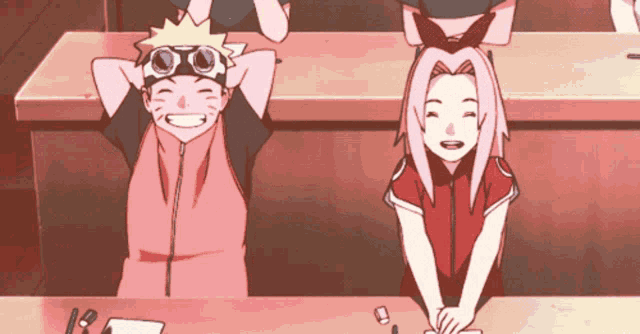 a boy and a girl are sitting at a table and smiling