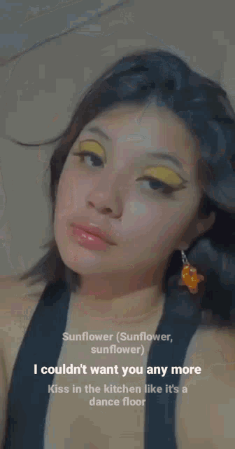 a close up of a woman 's face with yellow eyeshadow