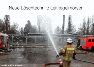 a fireman is spraying water from a hose with the caption " neue loschtechnik "