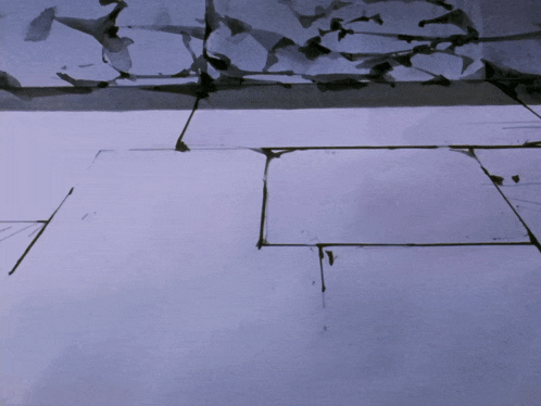 a purple tile floor with a few pieces of paper on it
