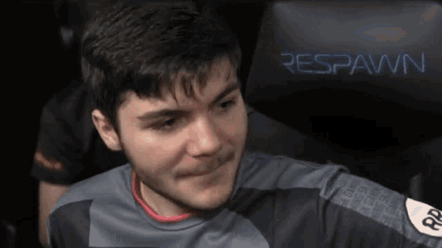 a man is sitting in a chair with the word respawn on it