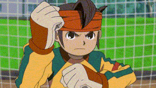 a cartoon character is standing in front of a soccer goal with his fist in the air .