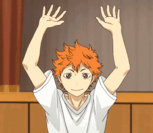 a boy with orange hair and a white shirt is raising his arms in the air