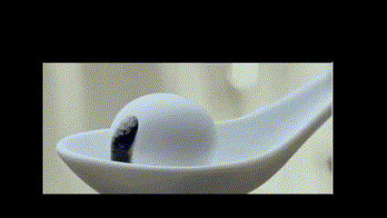 a white spoon with a ball on it