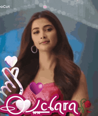a woman in a pink dress stands in front of a sign that says ' clara '
