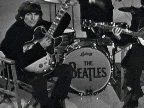 a black and white photo of the beatles band
