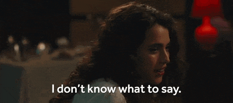 a woman is sitting at a table and saying `` i don t know what to say . ''