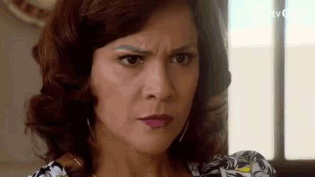 a close up of a woman 's face making a funny face .