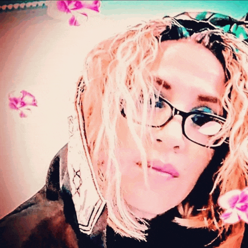 a woman wearing glasses and a scarf has flowers flying around her head