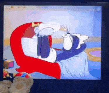 a cartoon of tom and jerry laying in a chair