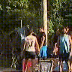 a group of people are standing around a pole and one of them has the number 11 on his back