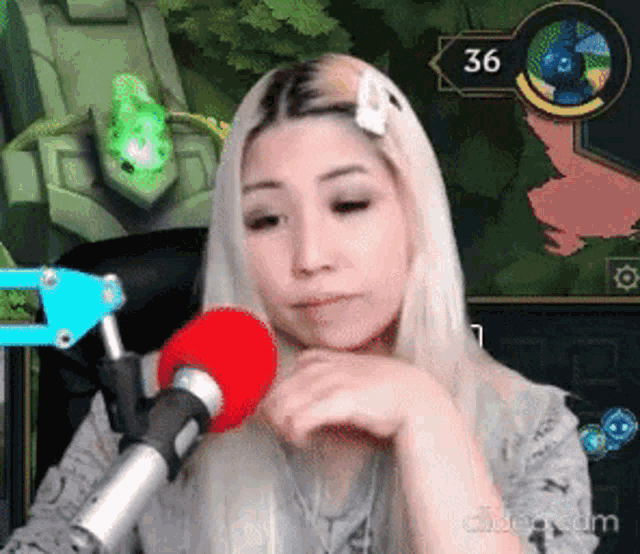 a woman is sitting in front of a microphone while playing a game .