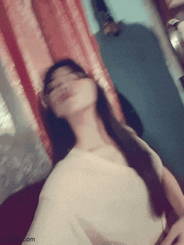 a blurry picture of a woman taking a selfie