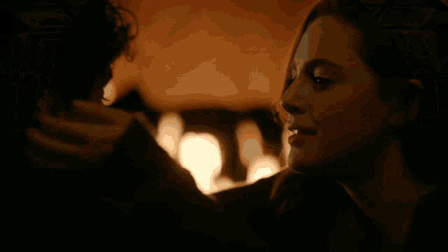 a man and a woman are looking into each others eyes