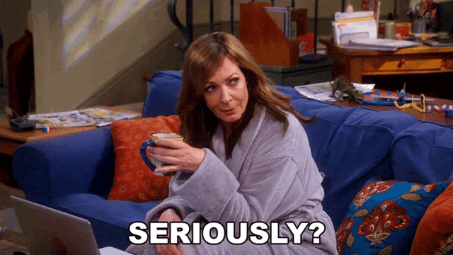 a woman is sitting on a couch with a laptop and a cup of coffee and the words " seriously " next to her