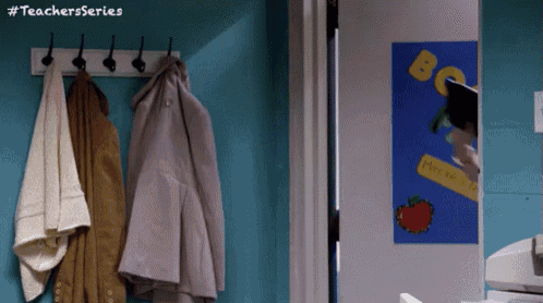 a teachers series poster hangs on a blue wall next to a coat rack