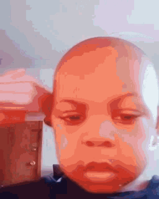 a close up of a baby 's face with a blurred background