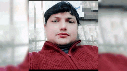 a man in a red sweater is taking a picture of himself